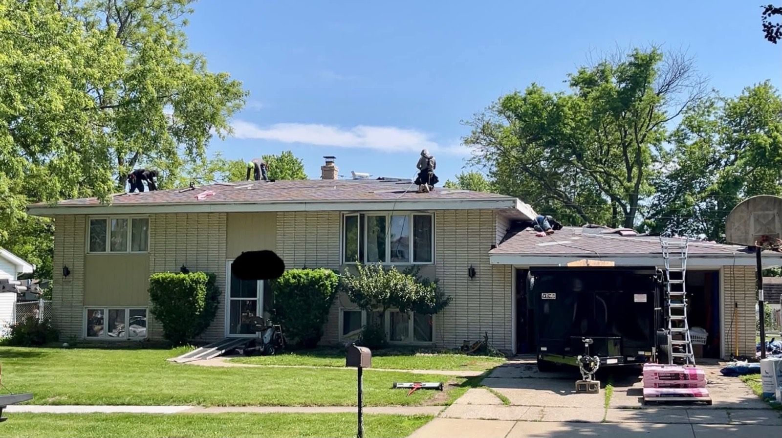 MSB roofing crew installing new shingles on a split-level home