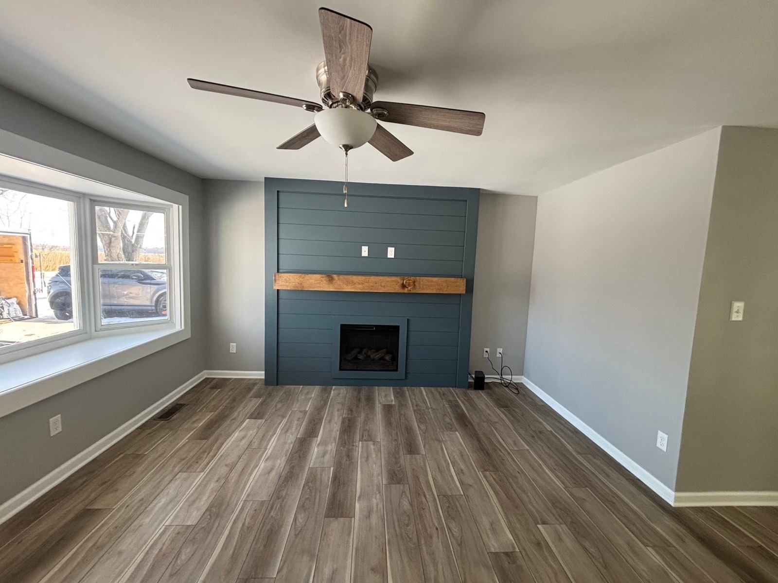 Remodeled living room with shiplap fireplace accent wall